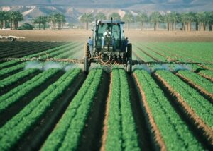 Farmer on tractor using pesticides - Integrated Pest Management (IPM) - Stein Tree